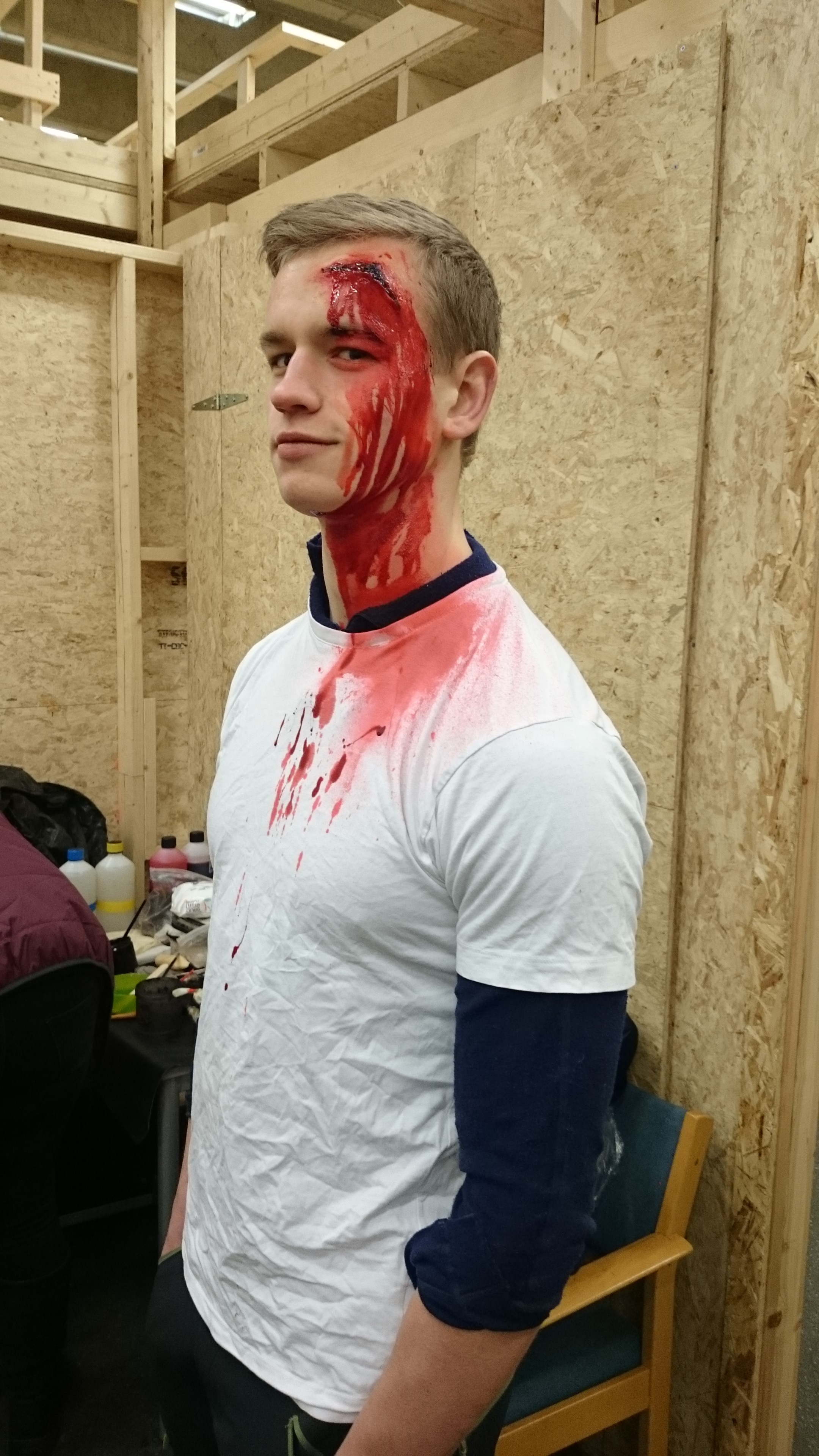 Actor with sfx makeup of an injury to the head, about to take part in a casualty simulation